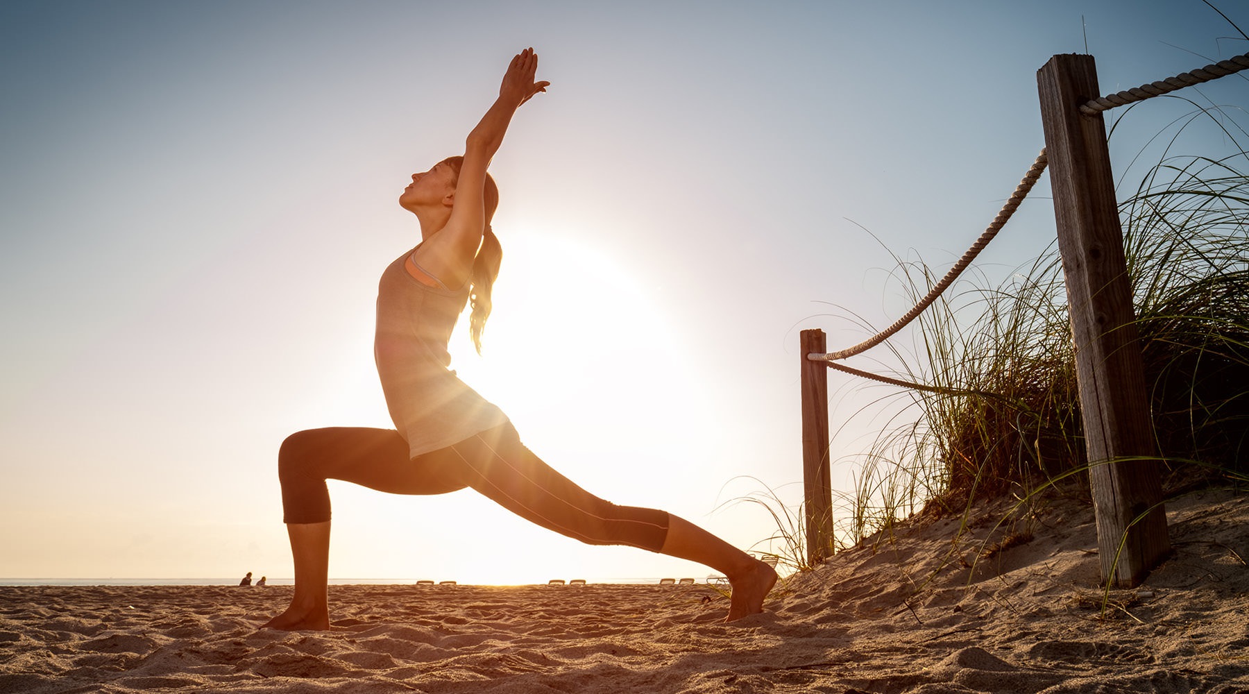 woman stretching on the beach